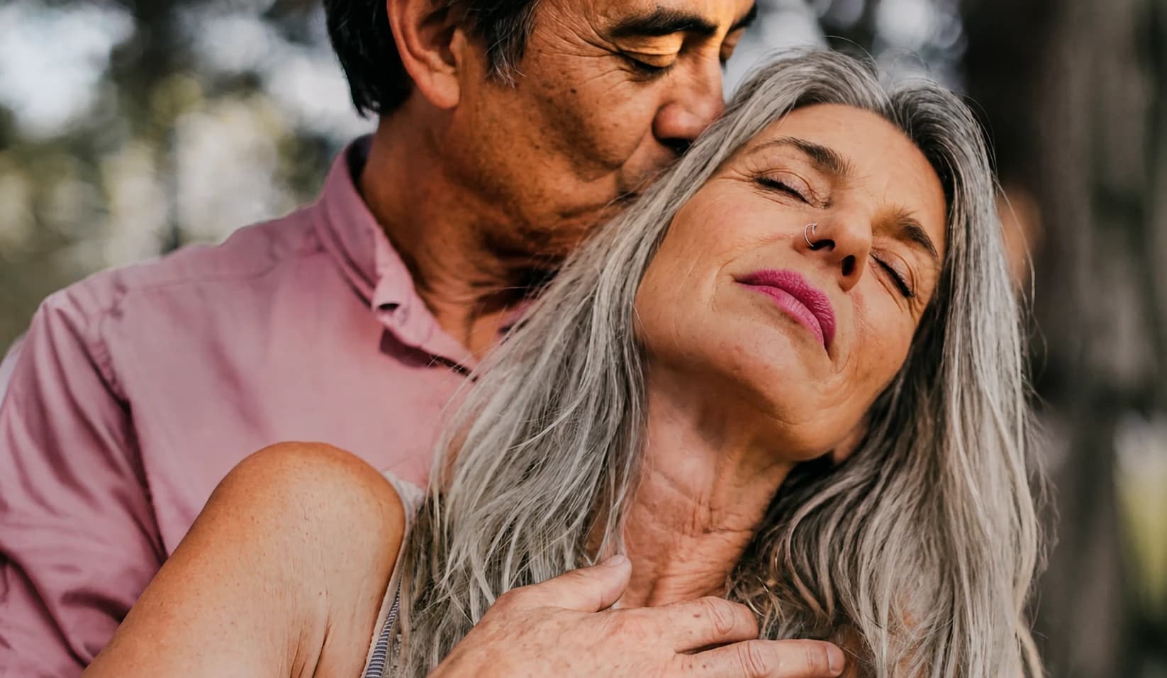 A couple sharing a quiet embrace outdoors